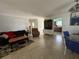 Large open living space with terrazzo flooring, connecting dining and sitting areas at 2175 20Th Sw Ave, Largo, FL 33774