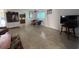 Open-concept living and dining area with terrazzo flooring and lots of natural light at 2175 20Th Sw Ave, Largo, FL 33774