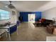 Spacious living room with large windows, terrazzo flooring and a blue accent wall at 2175 20Th Sw Ave, Largo, FL 33774