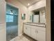 Bathroom with double granite vanity and white cabinetry, connecting to bedroom at 219 Lovely Ct, Plant City, FL 33566