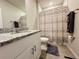Well lit bathroom with granite vanity, mirror and shower with patterned curtain at 219 Lovely Ct, Plant City, FL 33566