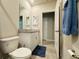 Bright bathroom with granite vanity, large mirror, and a blue bathmat at 219 Lovely Ct, Plant City, FL 33566