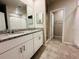 Bathroom featuring dual sink vanity with granite countertop, and tile flooring at 219 Lovely Ct, Plant City, FL 33566