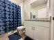 Clean bathroom featuring a blue shower curtain, granite vanity and framed mirror at 219 Lovely Ct, Plant City, FL 33566