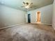 Spacious carpeted bedroom with a ceiling fan and an en-suite bathroom at 219 Lovely Ct, Plant City, FL 33566