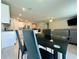 Spacious dining area with a sleek black table and chairs, seamlessly connecting to the kitchen and living room at 219 Lovely Ct, Plant City, FL 33566