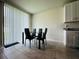 Bright dining area with a glass table and chairs, set against a backdrop of neutral walls and tile floors at 219 Lovely Ct, Plant City, FL 33566