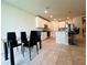Dining area with a modern glass table and chairs, complemented by neutral walls and tile flooring at 219 Lovely Ct, Plant City, FL 33566