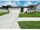 Charming single-story home with a well-manicured lawn, and a two car garage at 219 Lovely Ct, Plant City, FL 33566