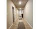 Well-lit hallway with tiled floors and access to rooms, creating a clean and inviting passage at 219 Lovely Ct, Plant City, FL 33566