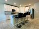 Modern kitchen featuring white cabinets, granite countertops, stainless steel appliances, and bar seating at 219 Lovely Ct, Plant City, FL 33566