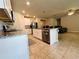 Modern kitchen featuring a center island with seating, stainless steel appliances, and white cabinetry at 219 Lovely Ct, Plant City, FL 33566