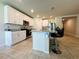 Contemporary kitchen with white cabinetry, granite countertops, stainless steel appliances, and a breakfast bar at 219 Lovely Ct, Plant City, FL 33566