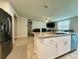 Open kitchen with a granite island and stainless steel appliances, perfect for modern living at 219 Lovely Ct, Plant City, FL 33566