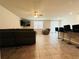 Open-concept living area with tile floors, a ceiling fan, and a breakfast bar with stool seating at 219 Lovely Ct, Plant City, FL 33566