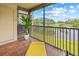 Relaxing screened balcony with chaise lounge overlooking a golf course and scenic water view at 2400 Feather Sound Dr # 528, Clearwater, FL 33762