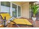 Cozy screened balcony with a chaise lounge, wine glasses, and a view of the golf course at 2400 Feather Sound Dr # 528, Clearwater, FL 33762