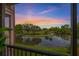 Scenic balcony view overlooking a lake and golf course at sunset with vibrant sky at 2400 Feather Sound Dr # 528, Clearwater, FL 33762