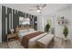 Well-decorated bedroom with modern accent wall, natural-tone wood bed, and stylish decor at 2400 Feather Sound Dr # 528, Clearwater, FL 33762