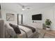 Bright bedroom featuring a ceiling fan, wall-mounted TV, modern decor, and wood-look flooring at 2400 Feather Sound Dr # 528, Clearwater, FL 33762