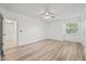 Large bedroom with wood-look floors, ceiling fan, and a large window allowing natural light at 2400 Feather Sound Dr # 528, Clearwater, FL 33762