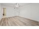 Bright bedroom with modern wood-look flooring and access to an ensuite bathroom at 2400 Feather Sound Dr # 528, Clearwater, FL 33762