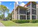 Exterior view of the building showcases screened-in balconies and well-maintained landscaping at 2400 Feather Sound Dr # 528, Clearwater, FL 33762