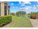 Landscaped exterior with a picturesque view of a tranquil pond and a golf course at 2400 Feather Sound Dr # 528, Clearwater, FL 33762
