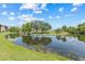 Scenic view overlooking a peaceful pond and lush golf course, reflecting a bright, sunny sky at 2400 Feather Sound Dr # 528, Clearwater, FL 33762