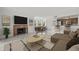 Open-concept living room with fireplace flowing into the dining area and modern kitchen at 2400 Feather Sound Dr # 528, Clearwater, FL 33762