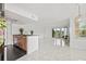 Bright, open living room features tile floors and a view of the balcony and golf course at 2400 Feather Sound Dr # 528, Clearwater, FL 33762
