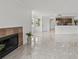 Open-concept living area with tile flooring, fireplace, and views into the kitchen at 2400 Feather Sound Dr # 528, Clearwater, FL 33762