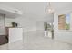 Bright, open living room features tile floors and a view of the balcony and golf course at 2400 Feather Sound Dr # 528, Clearwater, FL 33762