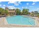 Beautiful community pool with ample lounge chairs, lush landscaping, and resort-style amenities at 2400 Feather Sound Dr # 528, Clearwater, FL 33762