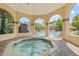 Spa featuring a jacuzzi under covered gazebo with views of pool and community buildings at 2400 Feather Sound Dr # 528, Clearwater, FL 33762