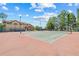 Well-maintained community tennis court with lighting for evening play and clubhouse in background at 2400 Feather Sound Dr # 528, Clearwater, FL 33762