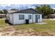 This backyard shows a small patio area, exterior door, and neutral color scheme at 2425 Wishing Well Cir, Tampa, FL 33619