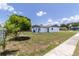 View of house exterior showcasing the well-maintained backyard with healthy green grass at 2425 Wishing Well Cir, Tampa, FL 33619