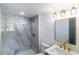 Modern bathroom featuring stylish lighting, a new vanity, gold hardware, and tiled shower at 2425 Wishing Well Cir, Tampa, FL 33619