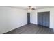 Bright bedroom features a ceiling fan, closet with gray doors, and wood-look flooring at 2425 Wishing Well Cir, Tampa, FL 33619