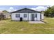 A house with a well-maintained lawn and exterior freshly painted in neutral tones at 2425 Wishing Well Cir, Tampa, FL 33619
