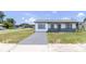 Charming single-story home featuring a freshly painted exterior and a well-maintained front lawn at 2425 Wishing Well Cir, Tampa, FL 33619