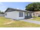 Well-maintained, charming single-story home with freshly painted exterior and a green lawn at 2425 Wishing Well Cir, Tampa, FL 33619