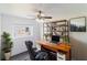 Bright home office with a large desk, shelving, and a comfortable leather chair at 2425 Wishing Well Cir, Tampa, FL 33619