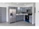 Charming kitchen with gray cabinets, a stainless steel refrigerator, and modern appliances at 2425 Wishing Well Cir, Tampa, FL 33619