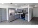 Bright kitchen features gray cabinets, stainless steel appliances, and a modern design at 2425 Wishing Well Cir, Tampa, FL 33619