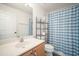 Bathroom with a sink, toilet, shelving and a blue and white plaid shower curtain at 24841 Mary Beth Ct, Land O Lakes, FL 34639