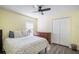 Bedroom features a ceiling fan, closet, and large windows allowing natural light to illuminate the space at 24841 Mary Beth Ct, Land O Lakes, FL 34639