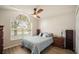 Bright bedroom featuring vaulted ceiling, large window, and hardwood floors at 24841 Mary Beth Ct, Land O Lakes, FL 34639
