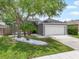 Charming single-story home featuring a two-car garage, landscaped yard, and mature trees at 24841 Mary Beth Ct, Land O Lakes, FL 34639